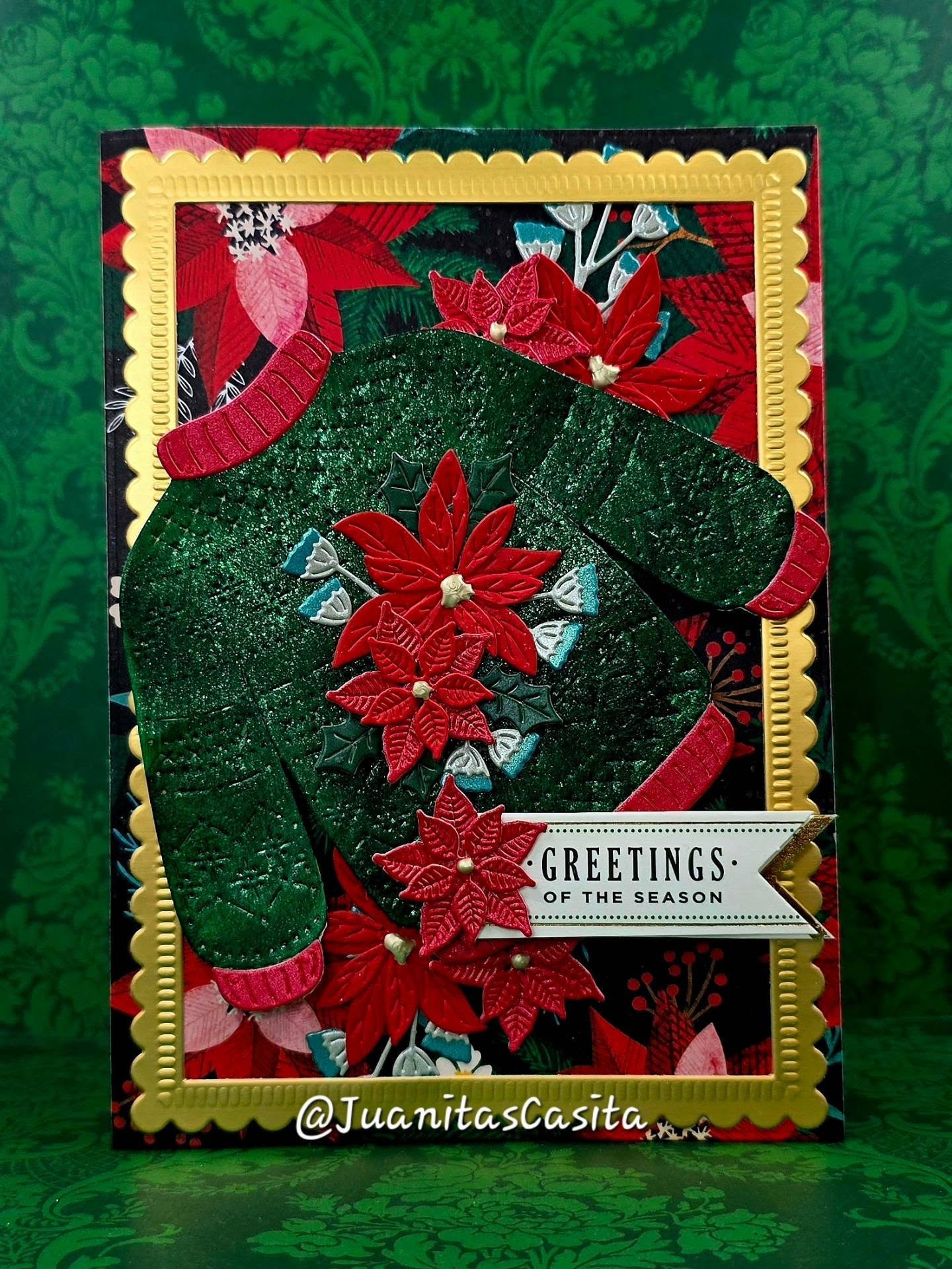 Card No.24 for week 24 of the Make One Christmas Card Every Week Challenge for 2026. I'm still playing catch up‼️ This die is from Spellbinders and initially, I tried inking it, but I did not like how it looked, and I didn't wanna waste this die cut, so I used some Lustre Polish in Glitzy Green. The Cosmic Shimmer brand was acquired by @katysuedesignscrafts March 2025.
OK now to my thoughts on how my Christmas sweater turned out! I started out with white card stock and then used a few different shades of green to shade it little.  But it just was not what I was looking for.  TO THE CRAFT CAVE, BATMAN!! 🦇 I remembered my friend @norarmenta9935 likes to use cosmic shimmer and lustre polish, so I grabbed a jar and went to work.  I think the final result I'm going to call "Christmas Pelusa". Pelusa is that fuzz, that lint that seems to never come off your fave sweater - also called pilling.  This sweater has a very much pilled look like the white underneath is coming through. So therefore I'm calling it pelusa! 

@teamspellbinders Stitched Christmas Sweater Dies, plus poinsettia dies

@annagriffininc 5x7 Frame Die, plus sentiment

@vickiboutin poinsettia cardstock Floral Sprig

#juanitascasita #feliznavidad #christmasCards #handmadecards #fyp
